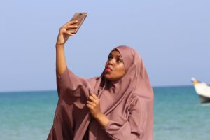 Woman Taking Selfie Near Shoreline